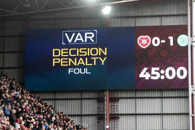 After VAR intervention, referee Nick Walsh awards a penalty for a foul in the box by Celtic's Cameron Carter-Vickers on Hearts' Cammy Devlin. (Photo by Mark Scates / SNS Group)