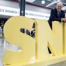First Minister John Swinney poses for photographs alongside his party’s logo at the SNP conference in Aberdeen (Picture: Jane Barlow/PA)