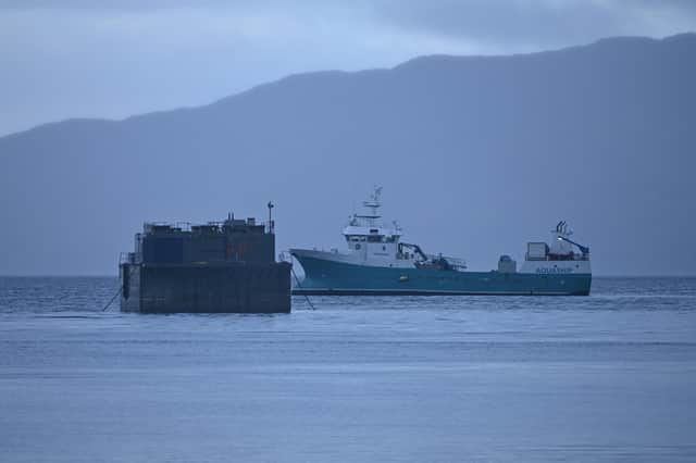 Work to remove the remainder of 690 tonnes of rotting fish feed and waste water from the wrecked barge has been continuing in Reraig bay, but deadlines for removal of the barge have repeatedly been missed by owner Bakkafrost