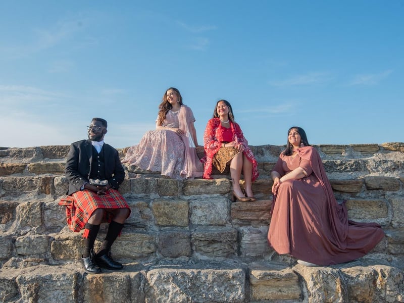 Patrick Obuobi from Ghana, Jannah Babar from Pakistan, Sherri Makhijani from Indonesia and Khrisha Patel from India dressed in national dress on the Pier on their graduation day, Tuesday 13 June 2023