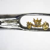 Micro-sculptor Dr Willard Wigan created this tiny model of the Queen's Coronation Carriage which fits inside the eye of a needle.
