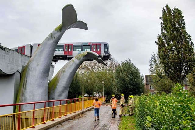 A Dutch metro train was saved from disaster on Sunday night after it smashed through a safety barrier but was prevented from plummeting into water by a sculpture of a whale tail. (Photo by Robin Utrecht / ANP / AFP)