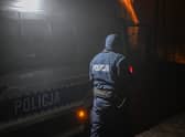 PRZEWODOW, POLAND - NOVEMBER 16: A police officer walks towards a check point as permitted cars are allowed to cross into the crime scene on November 16, 2022 in Przewodow, Poland. Poland convened a meeting of its national security council amid reports that stray missiles hit its territory, killing two people. Russia's defense ministry denied that its missiles hit the NATO member state, but moments after, Polish ministry confirmed it was a Russian-produced missile. (Photo by Omar Marques/Getty Images)