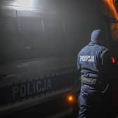 PRZEWODOW, POLAND - NOVEMBER 16: A police officer walks towards a check point as permitted cars are allowed to cross into the crime scene on November 16, 2022 in Przewodow, Poland. Poland convened a meeting of its national security council amid reports that stray missiles hit its territory, killing two people. Russia's defense ministry denied that its missiles hit the NATO member state, but moments after, Polish ministry confirmed it was a Russian-produced missile. (Photo by Omar Marques/Getty Images)