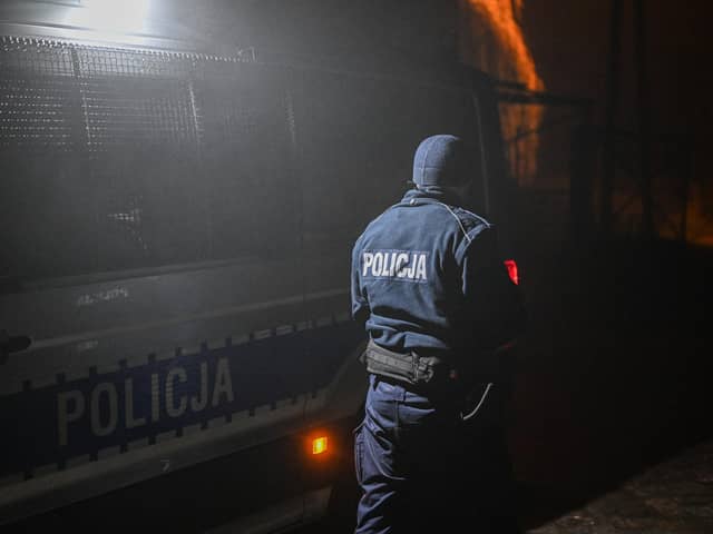 PRZEWODOW, POLAND - NOVEMBER 16: A police officer walks towards a check point as permitted cars are allowed to cross into the crime scene on November 16, 2022 in Przewodow, Poland. Poland convened a meeting of its national security council amid reports that stray missiles hit its territory, killing two people. Russia's defense ministry denied that its missiles hit the NATO member state, but moments after, Polish ministry confirmed it was a Russian-produced missile. (Photo by Omar Marques/Getty Images)