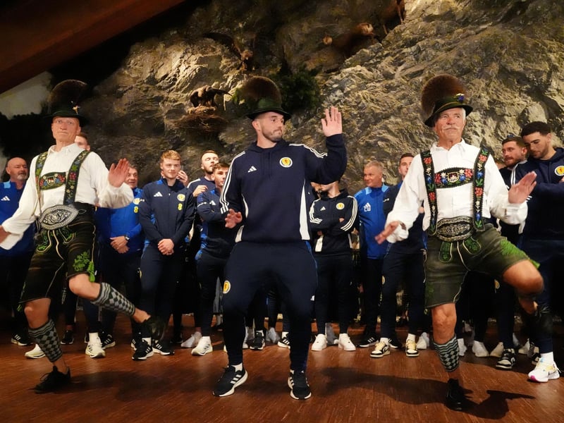 Scotland's John McGinn (centre) joins in with a dance as the team arrive at Bayernhalle in Garmisch-Partenkirchen, Germany, for a reception hosted by the Mayor.