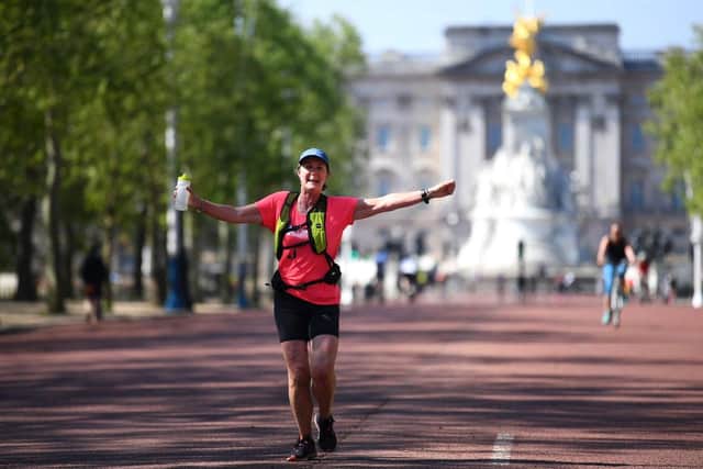A runner celebrates on the Mall , where the finish of the London Marathon was due to take place after running 2.6 miles instead of 26 miles to raise money for The Running Charity (Photo: Alex Davidson/Getty Images)