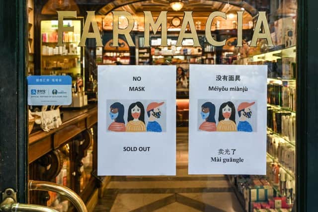 A sign advising clients in various languages that respiratory masks are sold out at a pharmacy in downtown Rome (Photo: ALBERTO PIZZOLI/AFP via Getty Images)