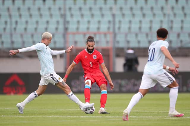 Scotland striker Lyndon Dykes challenges Luxembourg defender Vahid Selimovic for the ball during the Scots' 1-0 friendly victory. (Photo by Christian Kaspar-Bartke/Getty Images)