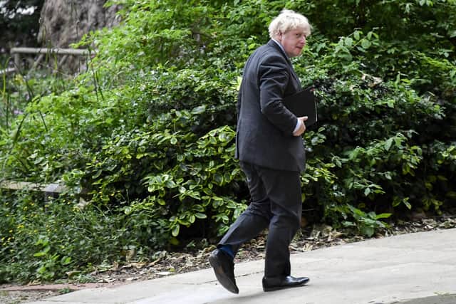 Britain's Prime Minister Boris Johnson walks to 9 Downing Street ahead of his press conference. Picture: AP Photo/Alberto Pezzali