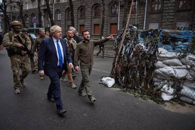 A handout photo released by the Ukrainian Presidential Press Service shows British Prime Minister Boris Johnson (L) and Ukrainian President Volodymyr Zelensky (R) walking in central Kyiv, on April 9, 2022. - British Prime Minister Boris Johnson paid an unannounced visit to Kyiv on April 9, 2022 in a "show of solidarity" with Ukraine a day after a missile strike killed dozens at a railway station in the country's east. (Photo by Stringer / UKRAINIAN PRESIDENTIAL PRESS SERVICE / AFP)