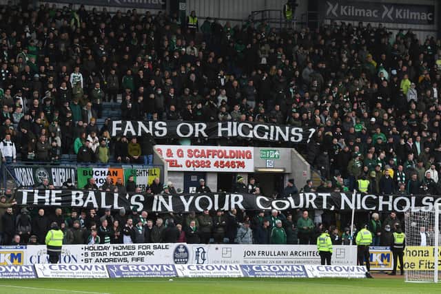 Celtic fans protest against Bernard Higgins during the cinch Premiership match against Dundee.