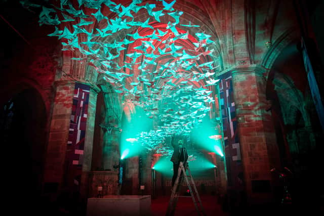 Artist Michael Pendry puts the finishing touches to his 'art for peace installation Les Colombes at St Giles' Cathedral in Edinburgh last year. Picture: Lloyd Smith