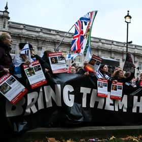 Protesters wave Israeli flags and hold photos of people held hostage by Palestinian militant group Hamas in Gaza, during a demonstration outside Downing Street last week. (Photo by JUSTIN TALLIS / AFP) (Photo by JUSTIN TALLIS/AFP via Getty Images)