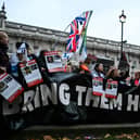 Protesters wave Israeli flags and hold photos of people held hostage by Palestinian militant group Hamas in Gaza, during a demonstration outside Downing Street last week. (Photo by JUSTIN TALLIS / AFP) (Photo by JUSTIN TALLIS/AFP via Getty Images)