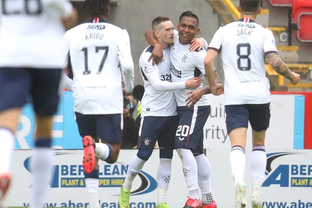 ABERDEEN, SCOTLAND - AUGUST 01: Ryan Kent of Rangers FC celebrates with Alfredo Morelos and team mates after scoring his team's first goal during the Ladbrokes Premiership match between Aberdeen and Rangers at Pittodrie Stadium on August 01, 2020 in Aberdeen, Scotland. Football Stadiums around Europe remain empty due to the Coronavirus Pandemic as Government social distancing laws prohibit fans inside venues resulting in all fixtures being played behind closed doors. (Photo by Andrew Milligan/Pool via Getty Images)