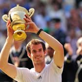Britain's Andy Murray raises the winner's trophy after beating Serbia's Novak Djokovic in the men's singles final on day thirteen of the 2013 Wimbledon Championships tennis tournament at the All England Club in Wimbledon.