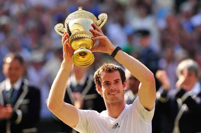 Britain's Andy Murray raises the winner's trophy after beating Serbia's Novak Djokovic in the men's singles final on day thirteen of the 2013 Wimbledon Championships tennis tournament at the All England Club in Wimbledon.