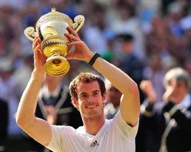 Britain's Andy Murray raises the winner's trophy after beating Serbia's Novak Djokovic in the men's singles final on day thirteen of the 2013 Wimbledon Championships tennis tournament at the All England Club in Wimbledon.
