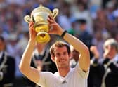 Britain's Andy Murray raises the winner's trophy after beating Serbia's Novak Djokovic in the men's singles final on day thirteen of the 2013 Wimbledon Championships tennis tournament at the All England Club in Wimbledon.
