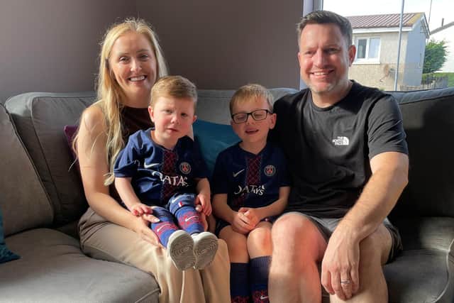 Zac McNab, sitting on his mother Arlene McNab from Clydebank, West Dunbartonshire, with his father Brian and brother Jake, six. Picture: Lucinda Cameron/PA Wire