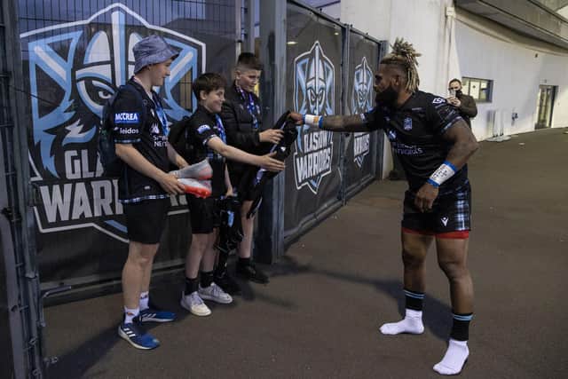 Niko Matawalu gives his boots away to fans after his final home match for Glasgow Warriors. Picture: Alan Harvey / SNS