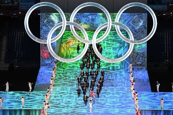 Britain's flag bearers Eve Muirhead and David Ryding lead the delegation as they enter the stadium during the opening ceremony of the Beijing 2022 Winter Olympic Games. Photo: Jewel SAMAD / AFP.