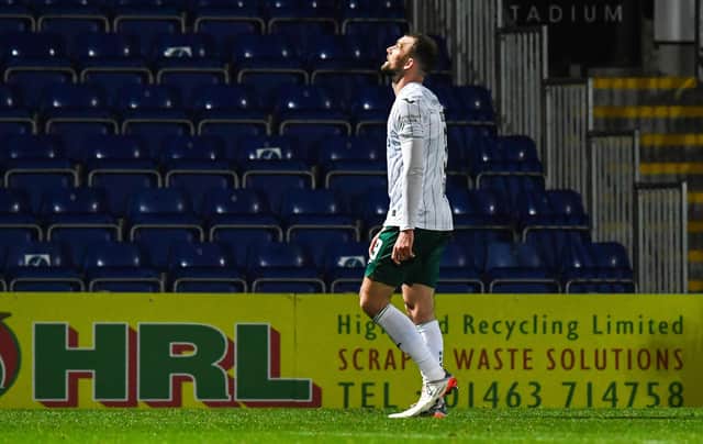 Hibs' Christian Doidge walks off after being shown a red card during a cinch Premiership match against Ross County.
