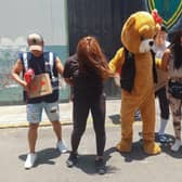 Undercover police squad members wishing to keep their anonymity pose at the doors of their headquarters in the district of San Martin in Lima, re-enacting a drug control operation gaining access as a Valentine's Day bear delivering a fake love surprise to raid and arrest drug dealers on Valentine's Day.