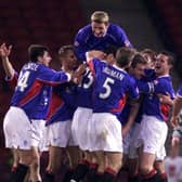 Estactic Rangers players mob Bert Konterman (hidden) after he scored the winner in extra time over Celtic in the 2001 CIS Cup semi-final at Hampden.