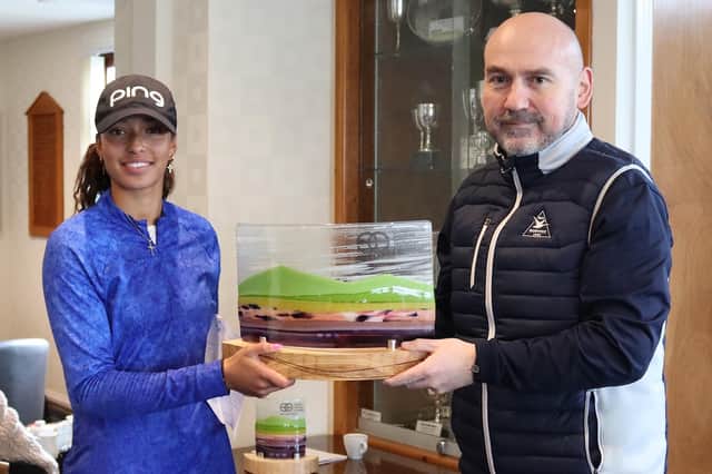 Woburn's Roisin Scanlon is presented with the trophy by the Northumberland club's general manager Keith Martin after winning the Stephen Gallacher Foundation Goswick Links Classic for the second year in a row. Picture: SGF