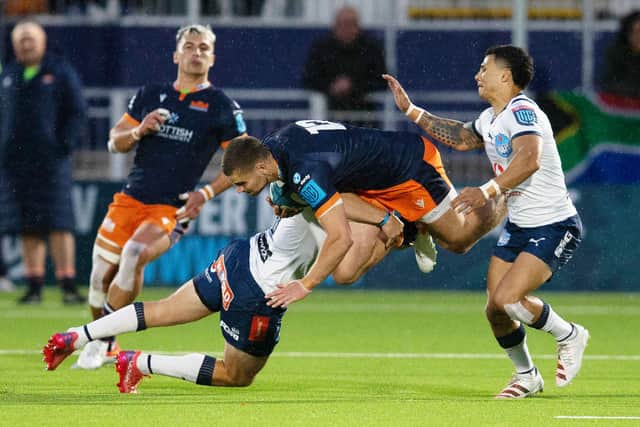 Edinburgh's James Lang is tackled by the Bulls' Chris Smith. Lang was also injured in the 17-10 win. Picture: Bruce White/SNS