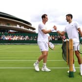 Andy Murray and Novak Djokovic shake hands after a practice session at Wimbledon. (Photo by Clive Brunskill/Getty Images)