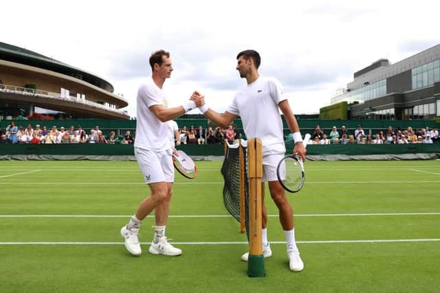 Andy Murray and Novak Djokovic shake hands after a practice session at Wimbledon. (Photo by Clive Brunskill/Getty Images)