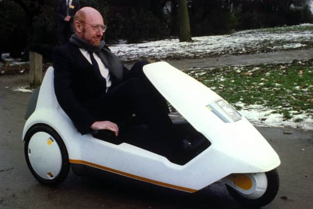 Sir Clive Sinclair demonstrating his C5 electric vehicle, the battery-come-pedal powered trike, at Alexandra Palace.