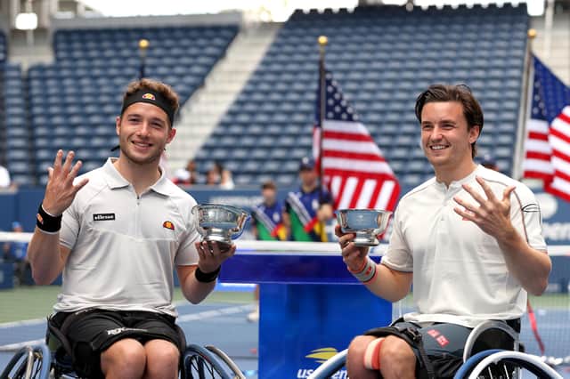 Gordon Reid (right) and Alfie Hewett celebrate with their championship trophies after winning the Wheelchair Men's Doubles final at the US Open. (Photo by Elsa/Getty Images)