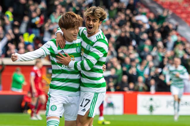 Celtic winger Jota, pictured right celebrating with Kyogo Furuhashi, is developing a telepathy on the pitch with the striker but he is determined to speak to his team-mate in his native Japanese off it.  (Photo by Ross MacDonald / SNS Group)