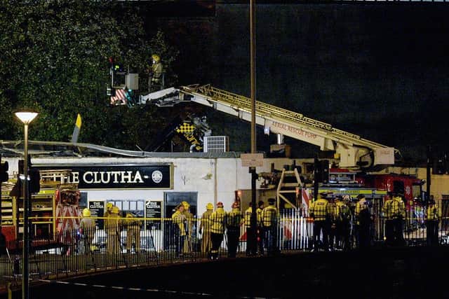 Rescue workers at the Clutha Bar in Glasgow after a Police Scotland helicopter crashed, killing all three crew and seven pub patrons. Picture: Jeff J Mitchell/Getty