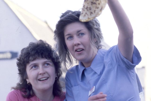 Susan Maughan (left) and Moira Baggott toss a pancake as a warm-up to the race across Elvet Bridge in 1988.