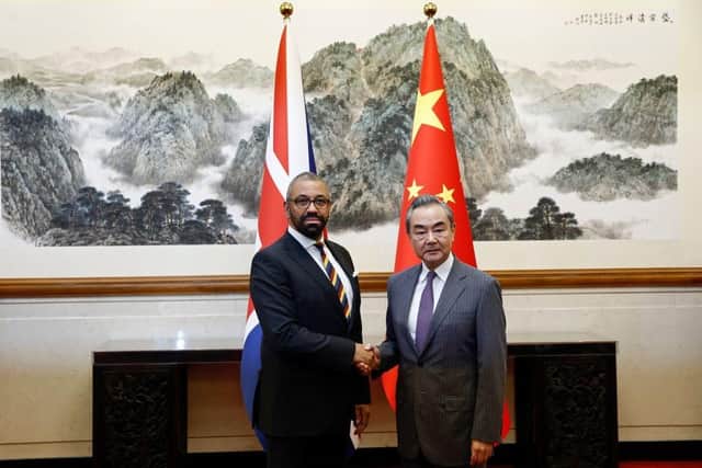 British Foreign Secretary James Cleverly (L) and Chinese Foreign Minister Wang Yi shake hands before a meeting at the Diaoyutai State Guesthouse in Beijing in August.