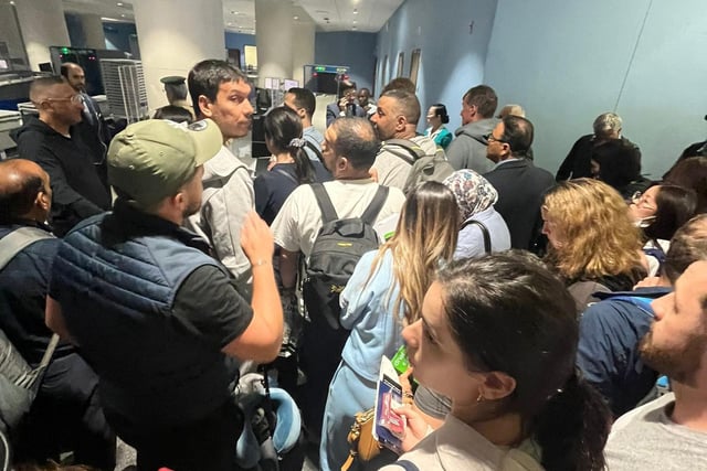 Hundreds of people wait at Dubai World Central airport because of flooding caused by the heaviest rain ever recorded in the desert nation.