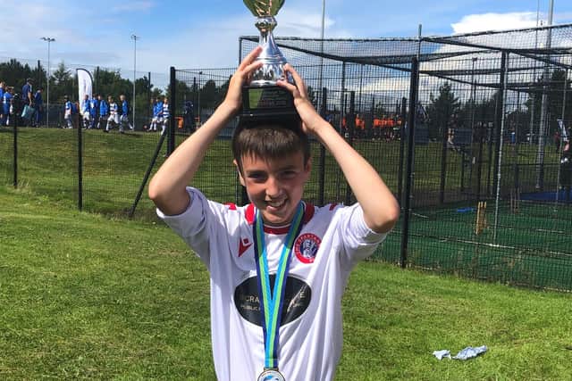 Proud moment for Spartans Reds as players celebrate with their medals and the cup