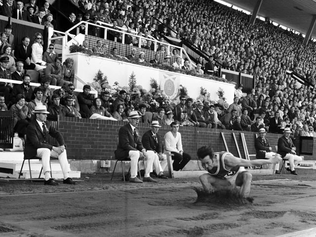 The Royal Family and the crowd watch as Wales' Lynn Davies completes his long jump to take the gold medal at the Commonwealth Games in Edinburgh in 1970.