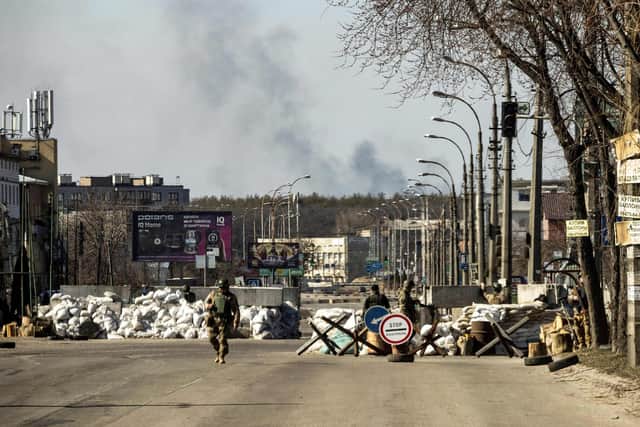 Ukrainian soldiers guard a checkpoint in the capital Kyiv (Picture: Fadel Senna/AFP via Getty Images)