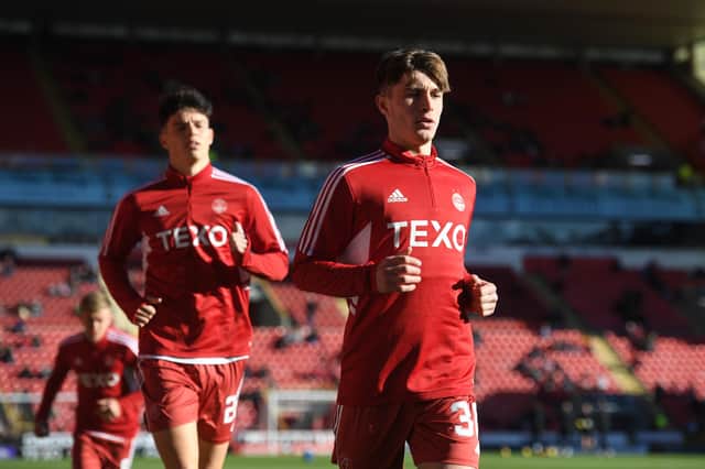 Aberdeen's Alfie Bavidge warms up before the 2-0 win over Hearts. He did not feature but it was the talented 16-year-old's first time in the squad (Photo by Craig Foy / SNS Group)