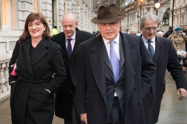 Iain Duncan Smith, wearing a hat with Conservative colleagues, has called for the lockdown to be unlocked (Picture: Stefan Rousseau/PA Wire)
