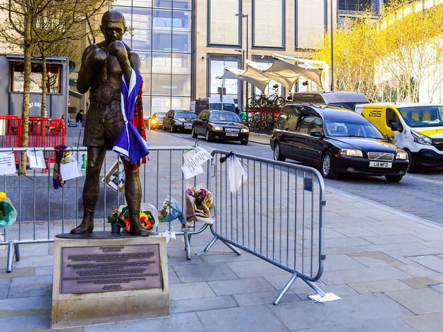The funeral procession of legendary Scottish boxing world champion Ken Buchanan MBE passes the Ken Buchanan statue ahead of a memorial service