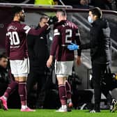 Hearts' Michael Smith goes off injured against Celtic on Wednesday.