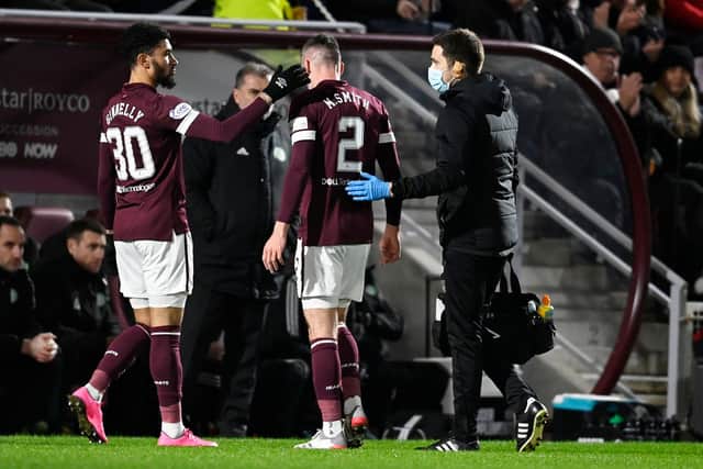 Hearts' Michael Smith goes off injured against Celtic on Wednesday.