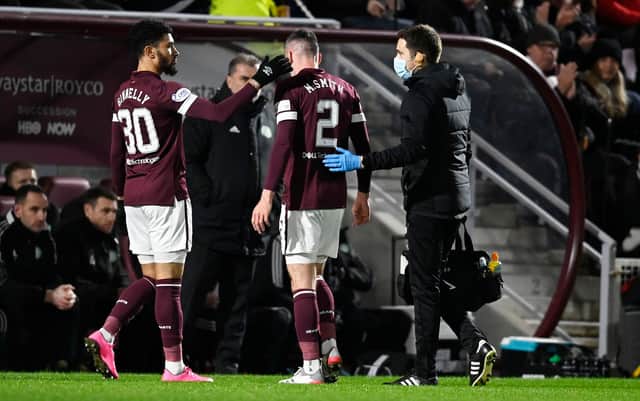 Hearts' Michael Smith goes off injured against Celtic on Wednesday.